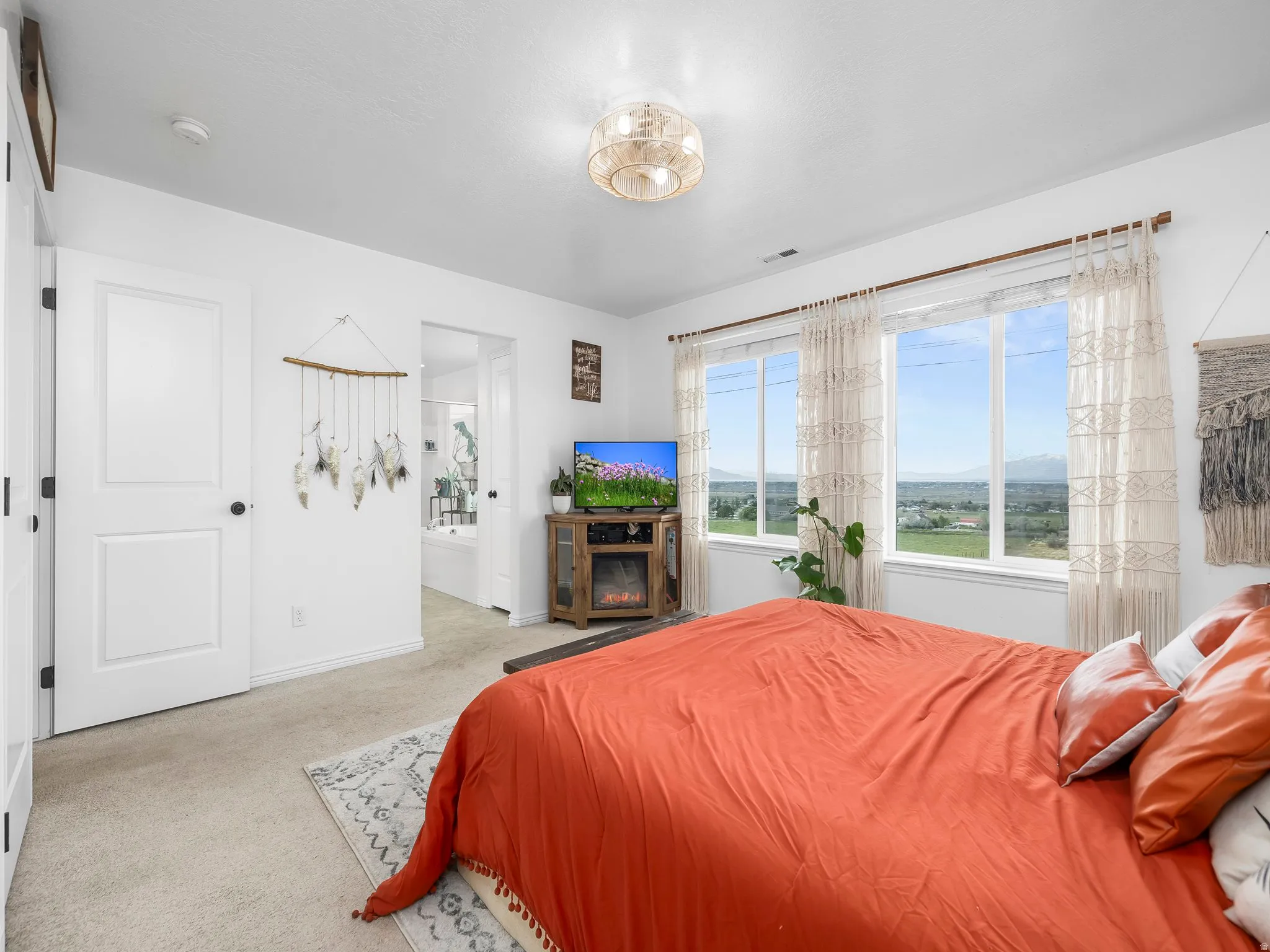 Bedroom with connected bathroom and carpet floors