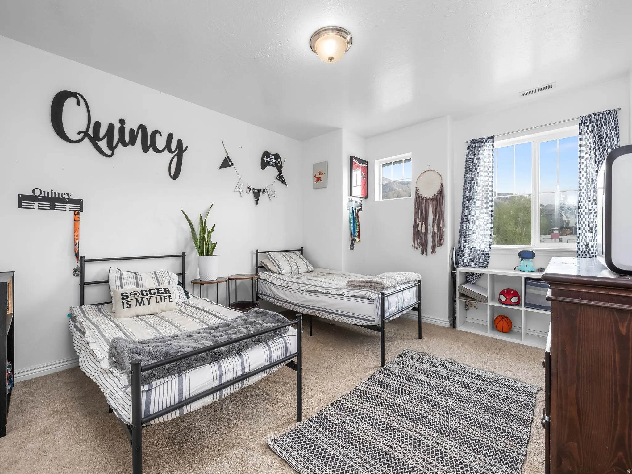 Bedroom featuring light carpet and baseboards