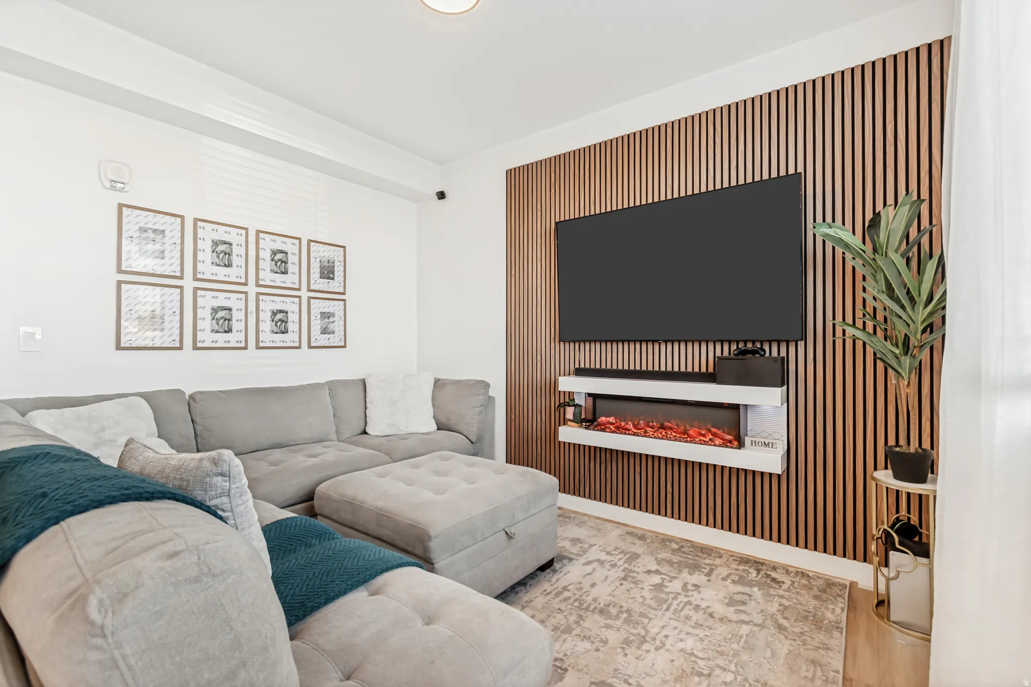 Living area with a glass covered fireplace and an accent wall