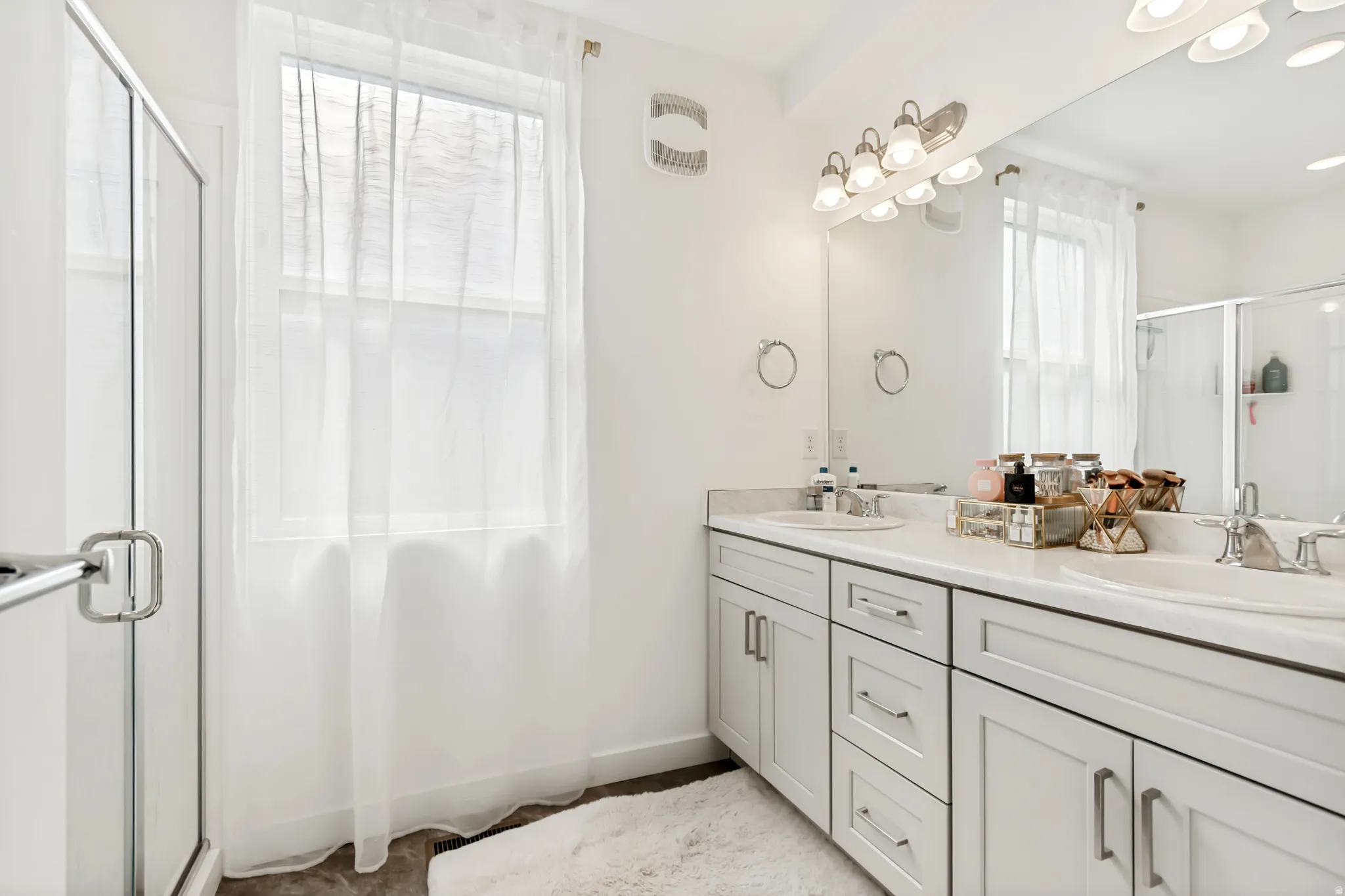 Bathroom with a stall shower and double vanity