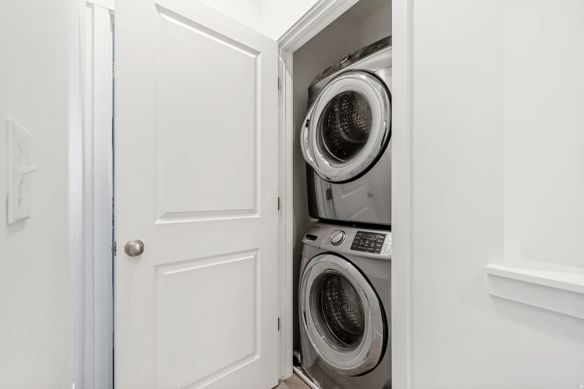 Laundry area featuring stacked washer and dryer