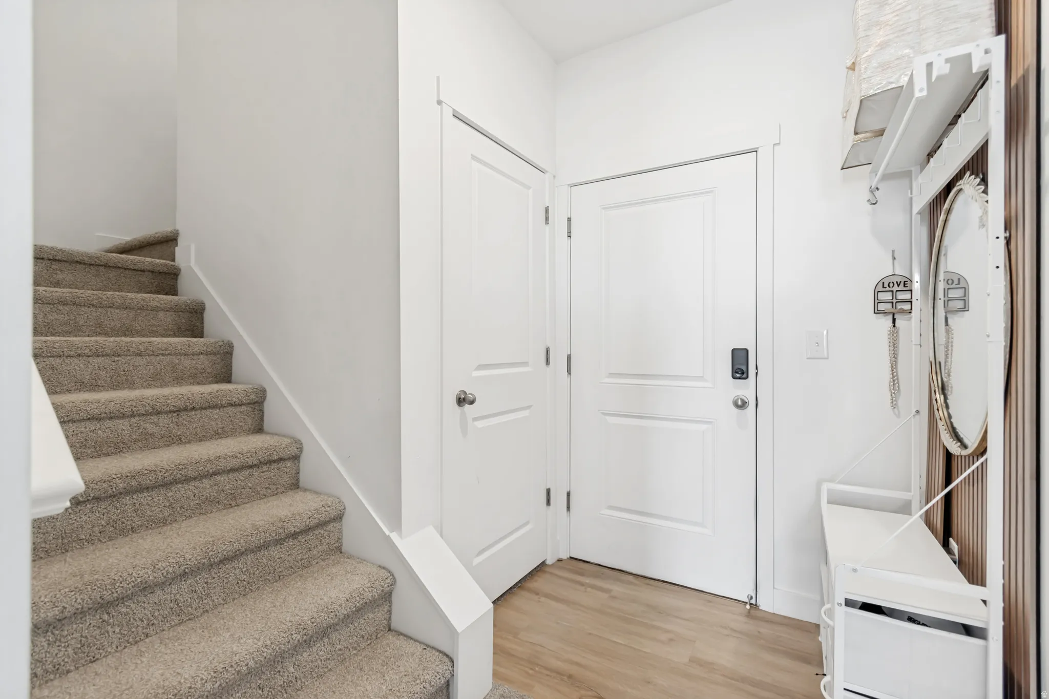 Entryway featuring stairway and light wood-style flooring