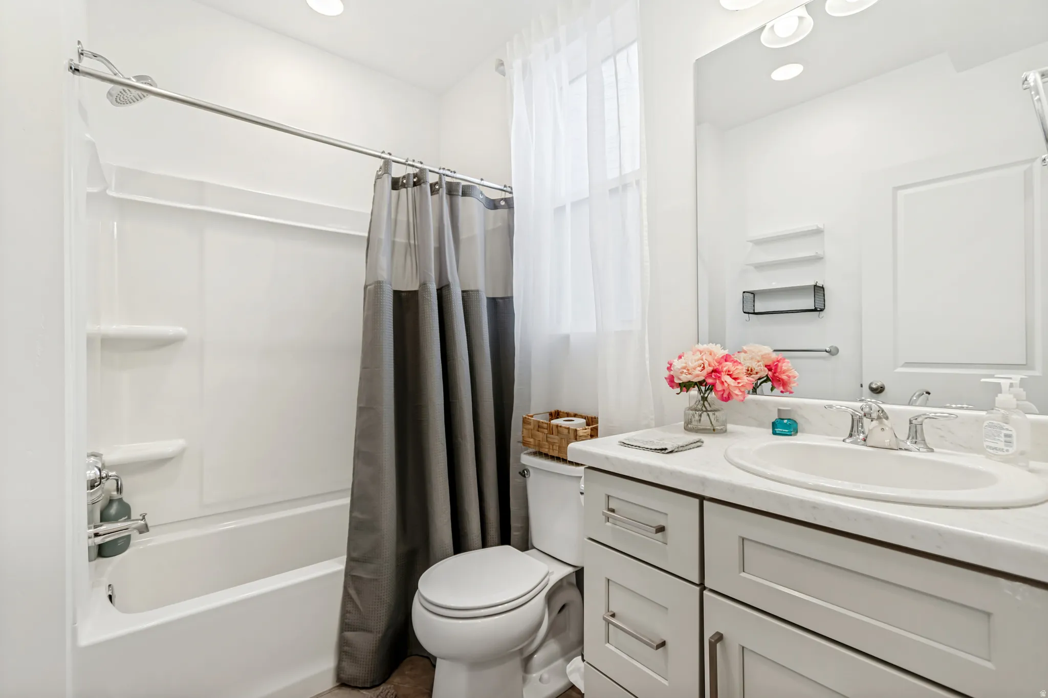 Full bathroom featuring vanity, shower / bathtub combination with curtain, and recessed lighting