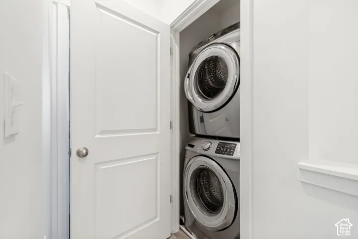 Laundry area featuring stacked washer and dryer