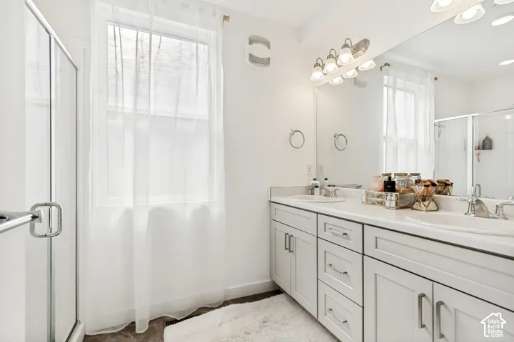 Bathroom with a stall shower and double vanity