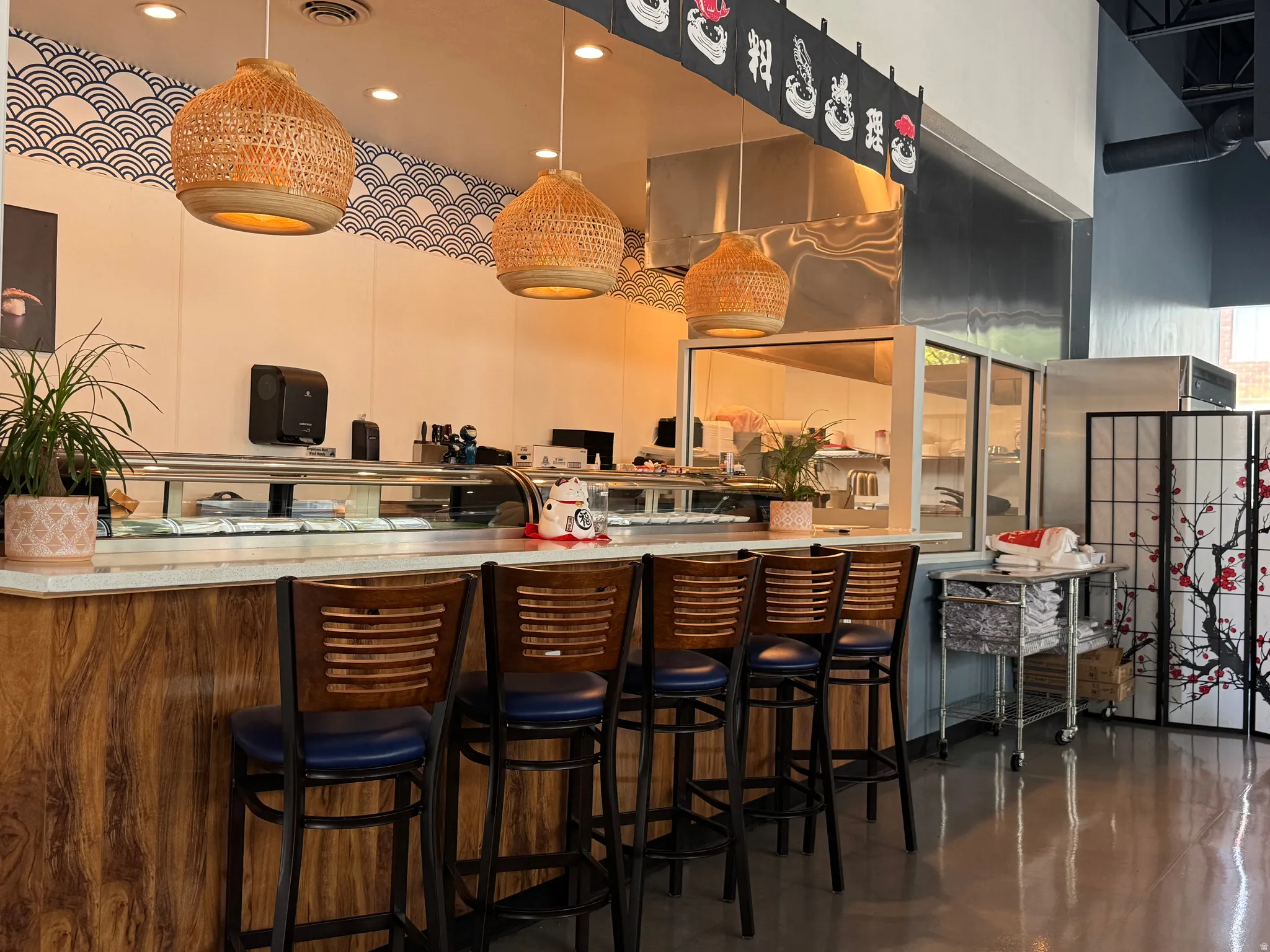 Bar featuring light countertops, hanging light fixtures, and a high ceiling