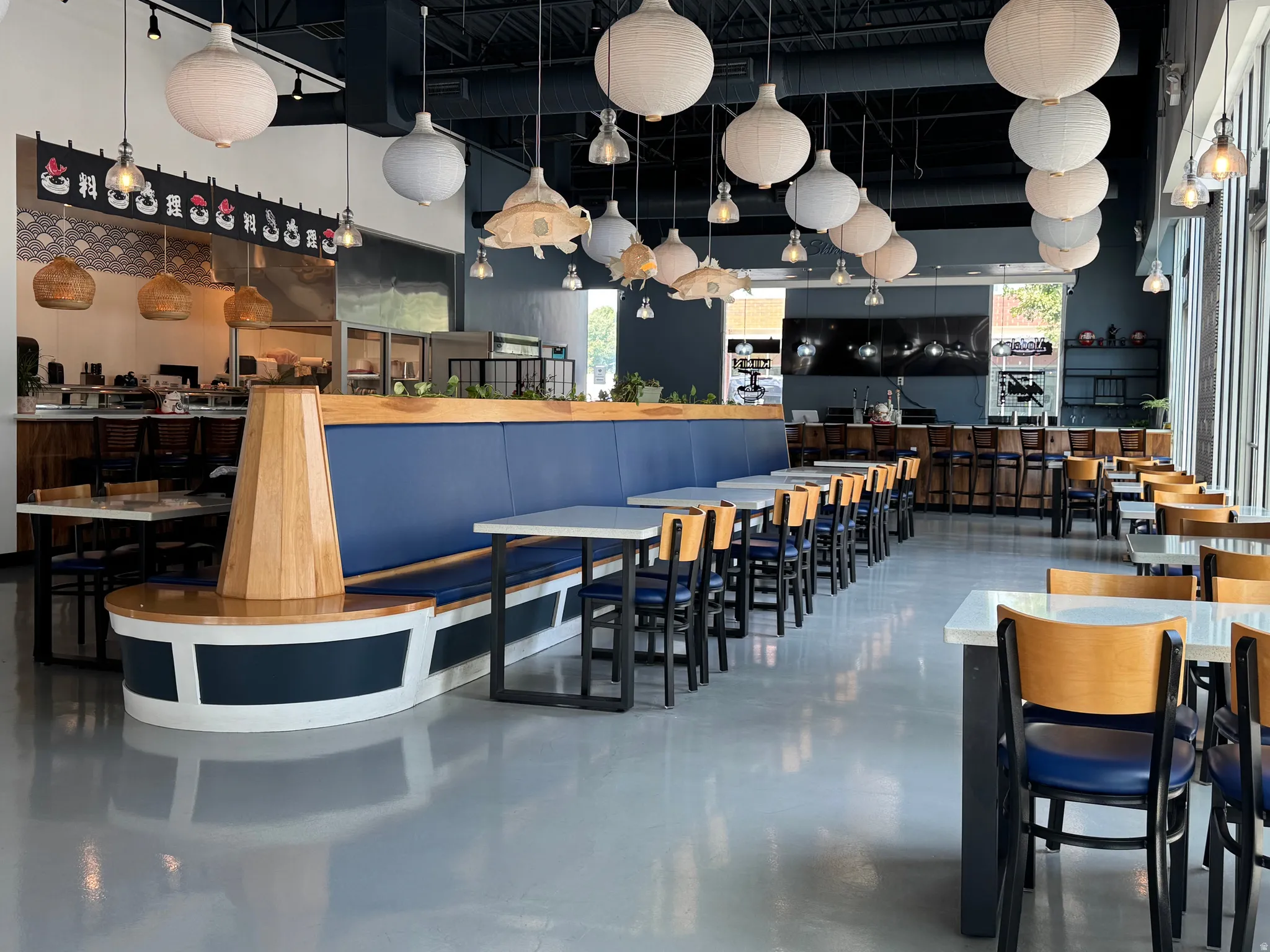 Dining space with finished concrete flooring and a high ceiling
