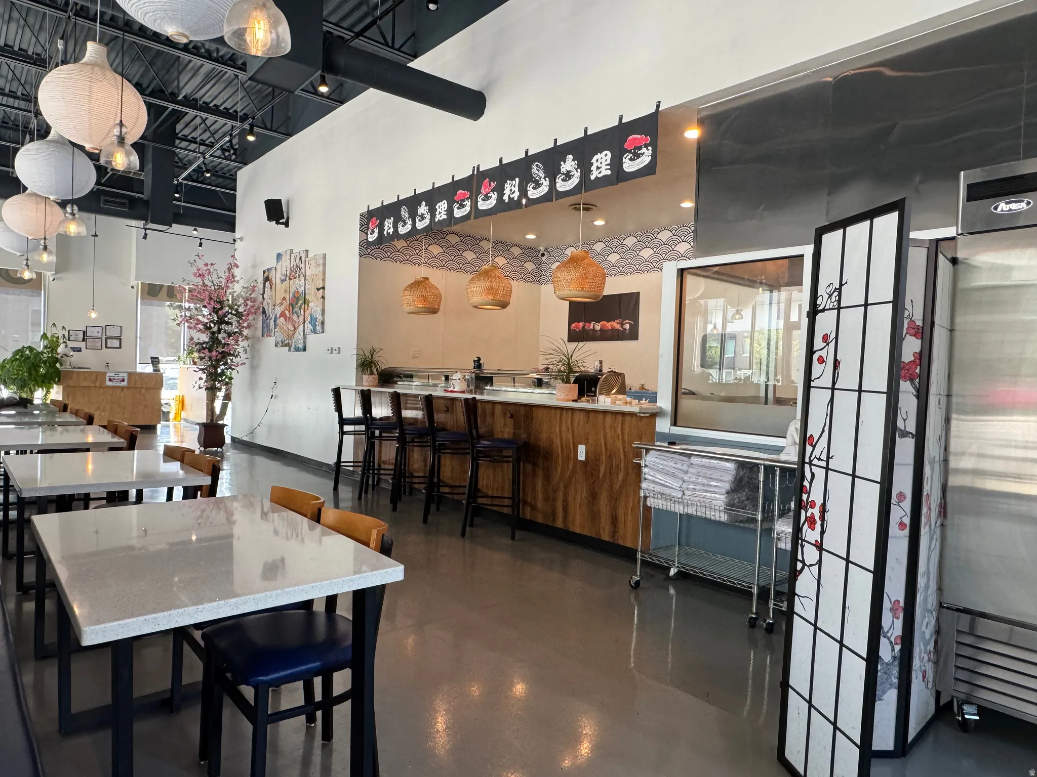 Dining space with finished concrete flooring and a high ceiling