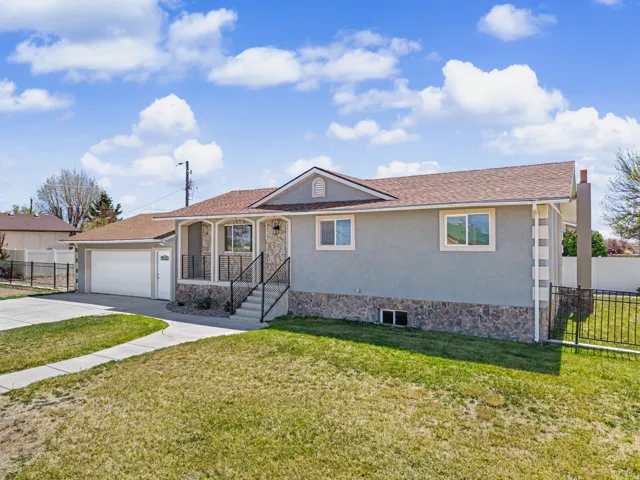 Ranch-style house featuring stucco siding, driveway, an attached garage, and roof with shingles