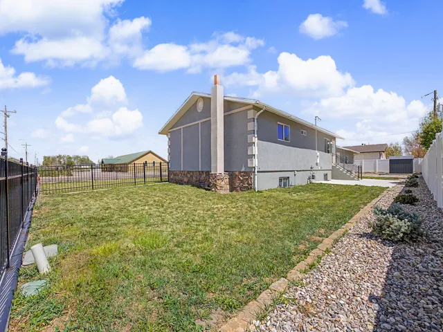 View of property exterior featuring stucco siding and a fenced backyard