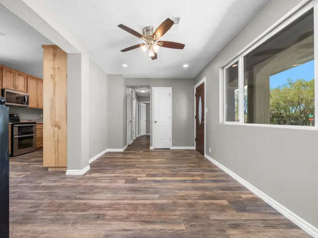 Hallway with dark wood finished floors and recessed lighting