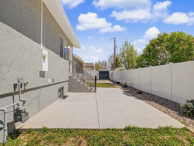 Fenced backyard with a patio area and a shed