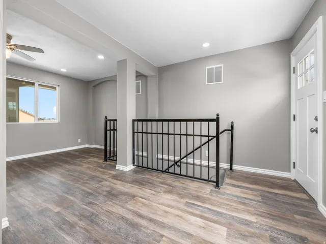 Foyer with dark wood finished floors, recessed lighting, a ceiling fan, and arched walkways