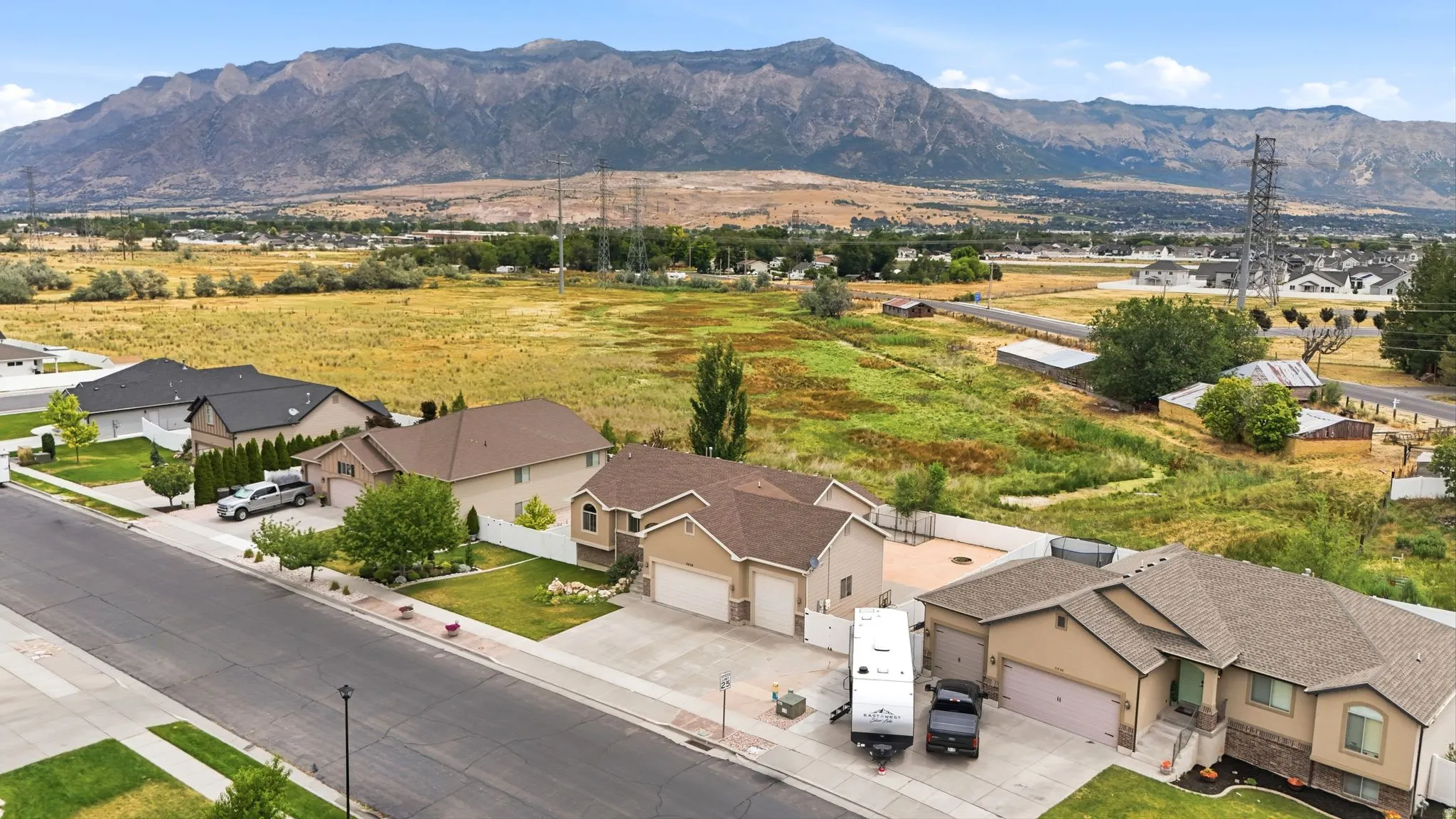 Aerial perspective showcasing properties against a mountainous backdrop
