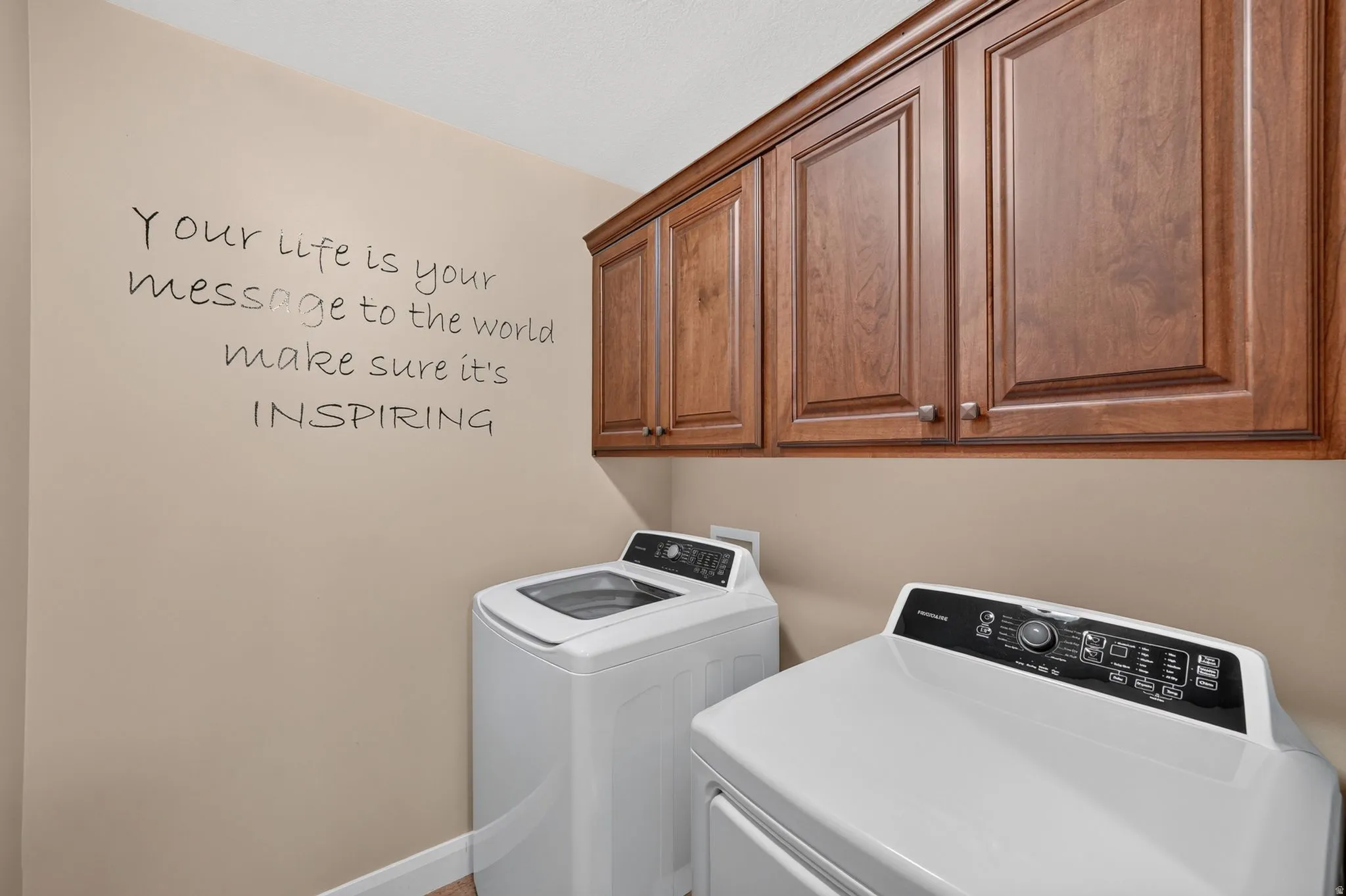 Dedicated laundry area featuring abundant cabinetry