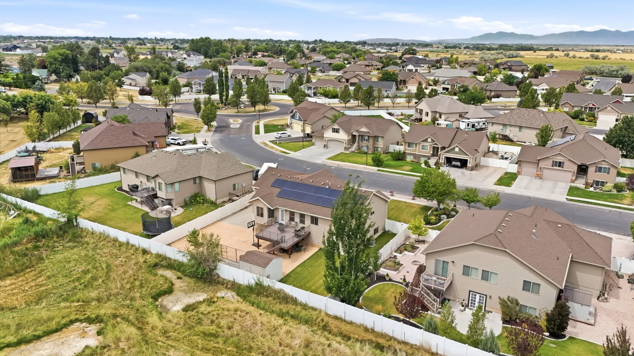 Aerial perspective of a residential neighborhood featuring several homes with mature landscaping