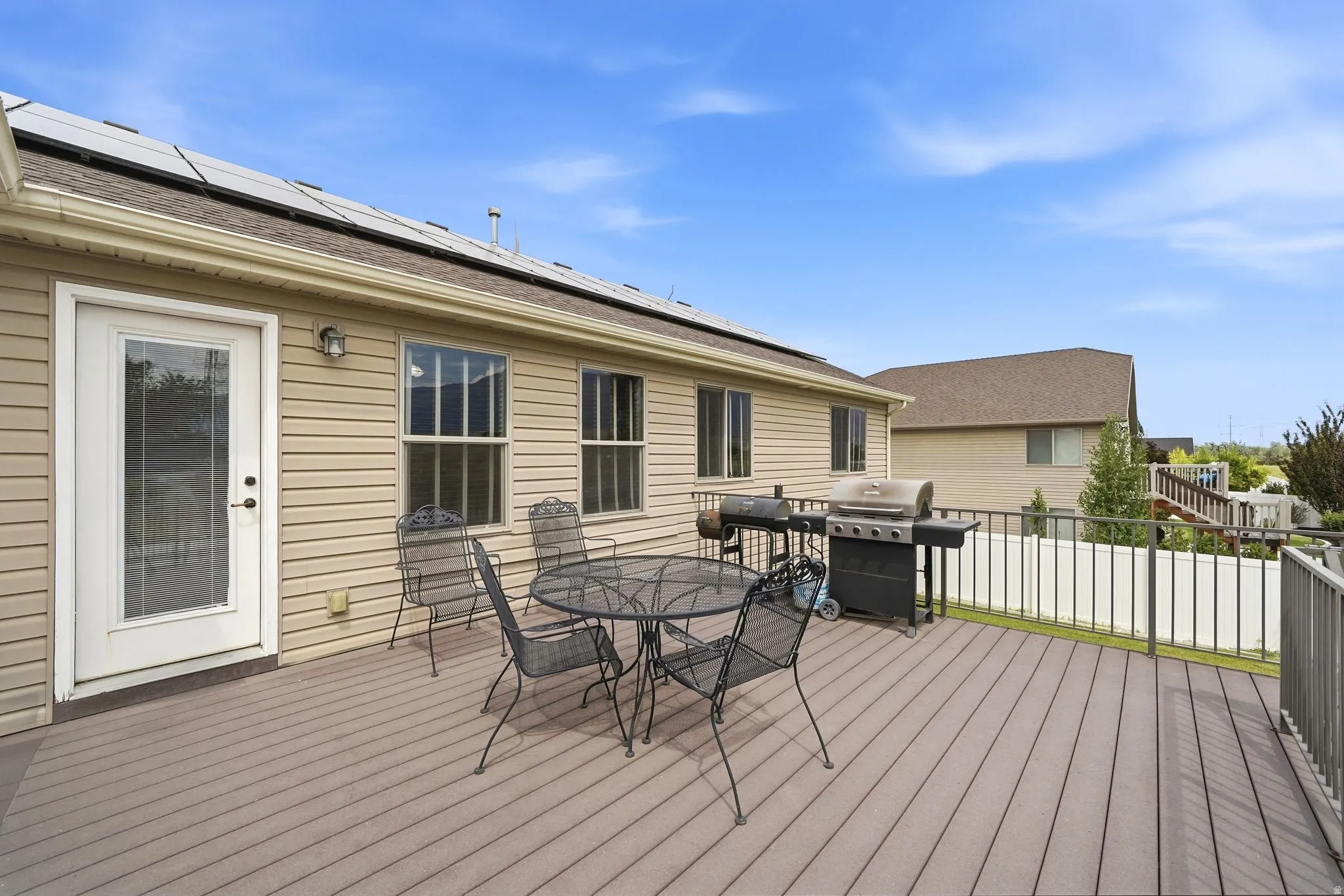 Exterior deck featuring composite decking and metal railings