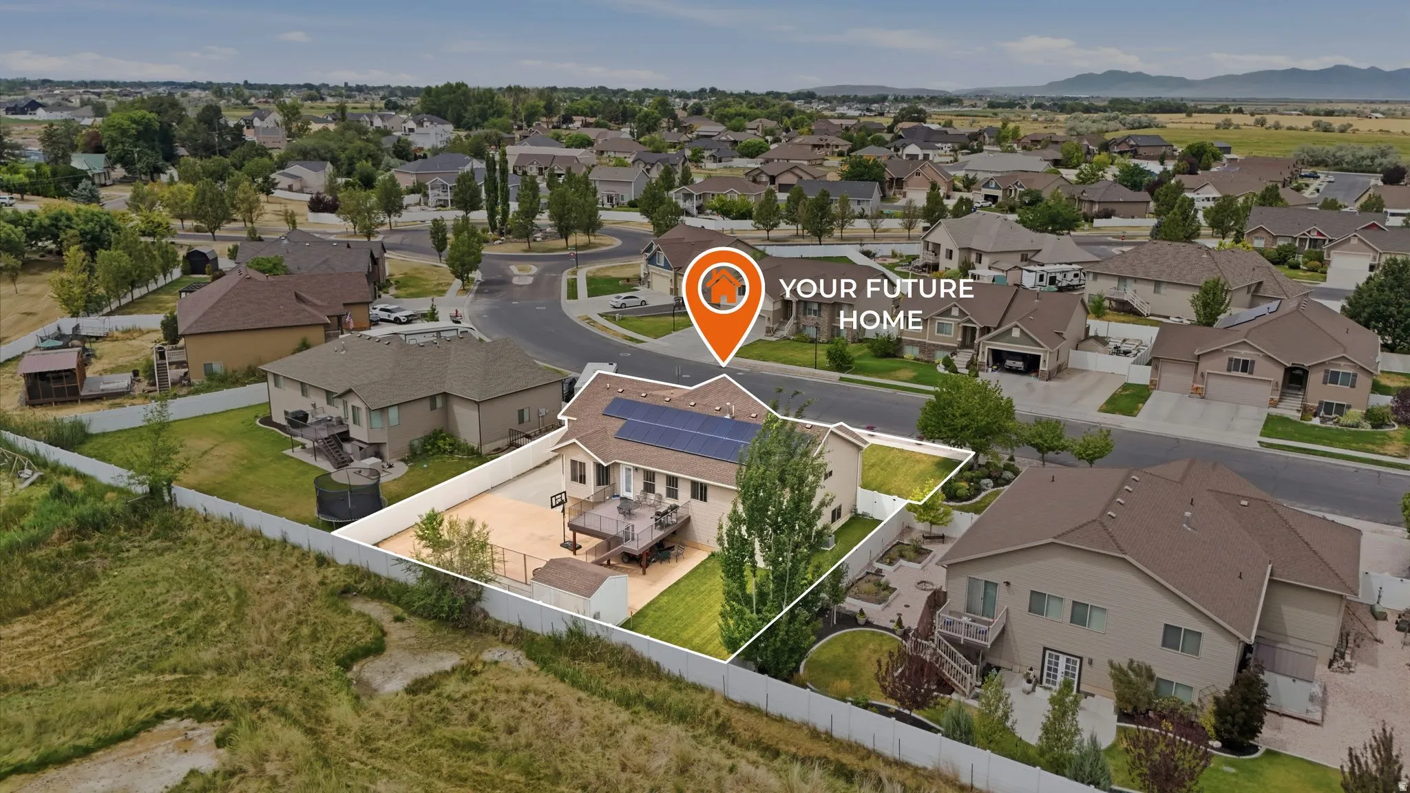 Aerial perspective of a tan residence featuring a brown shingle roof with solar panels