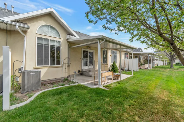 Rear view of property with stucco siding