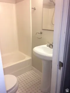 Full bath featuring shower / bathtub combination and light tile patterned flooring