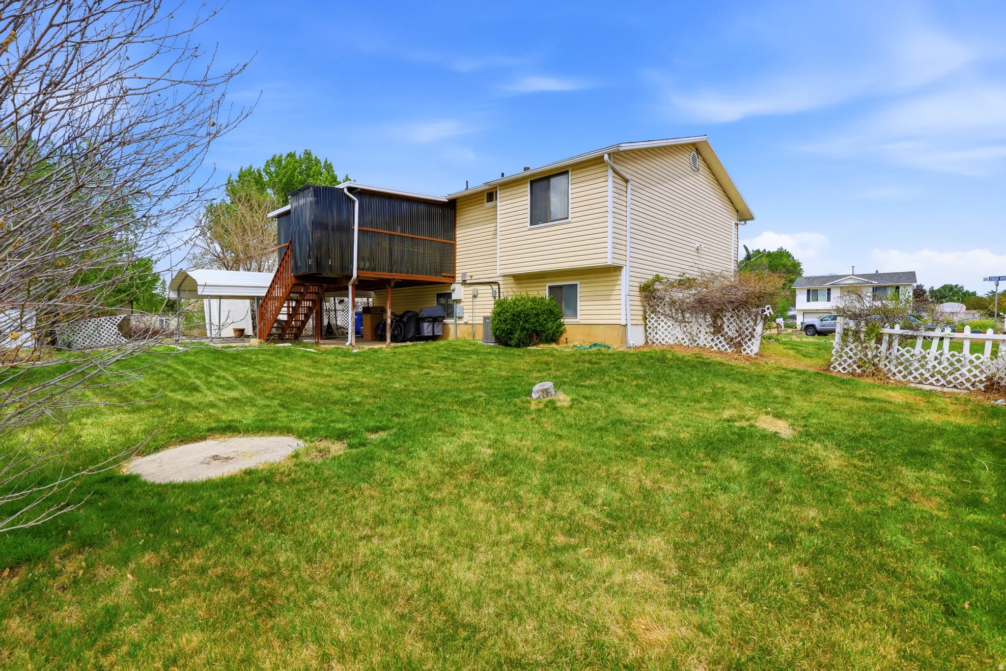 Back of property with a wooden deck and a shed