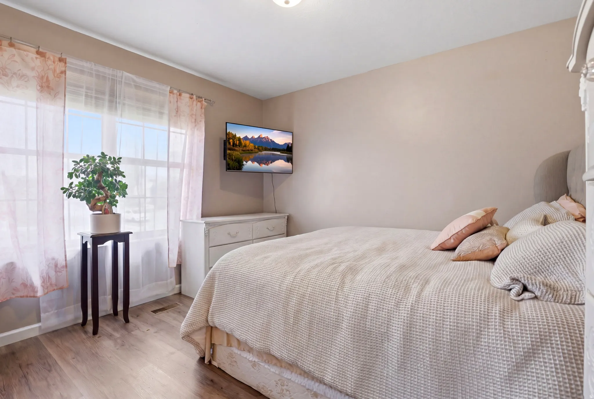 Bedroom featuring wood finished floors and baseboards