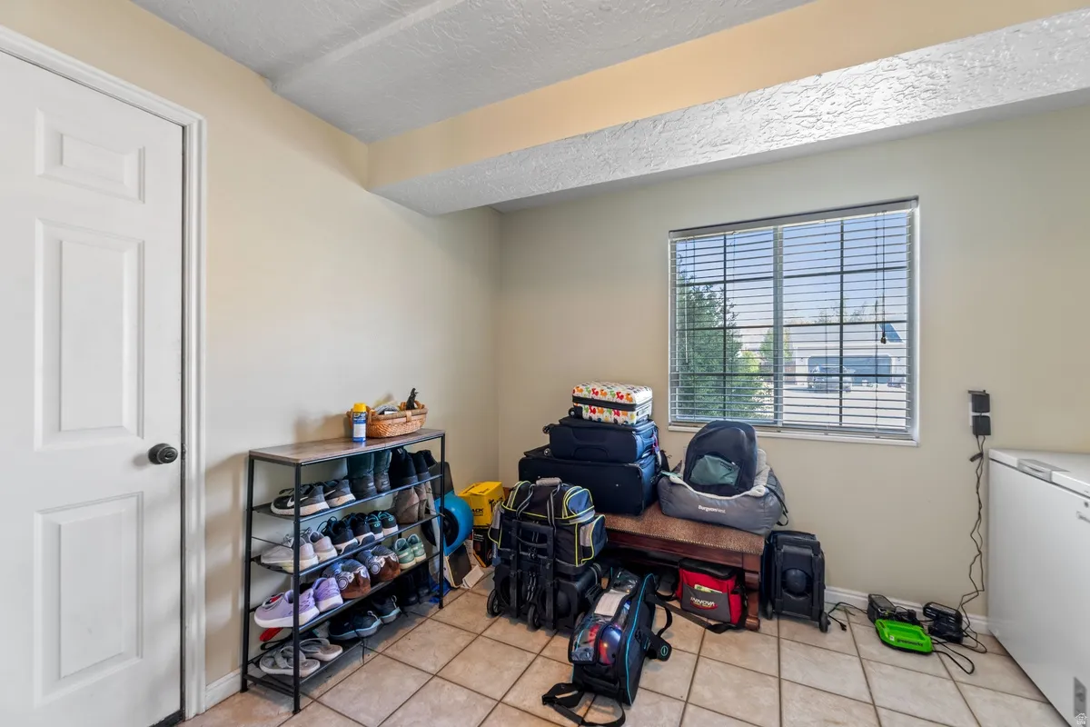 Misc room featuring light tile patterned floors and a textured ceiling