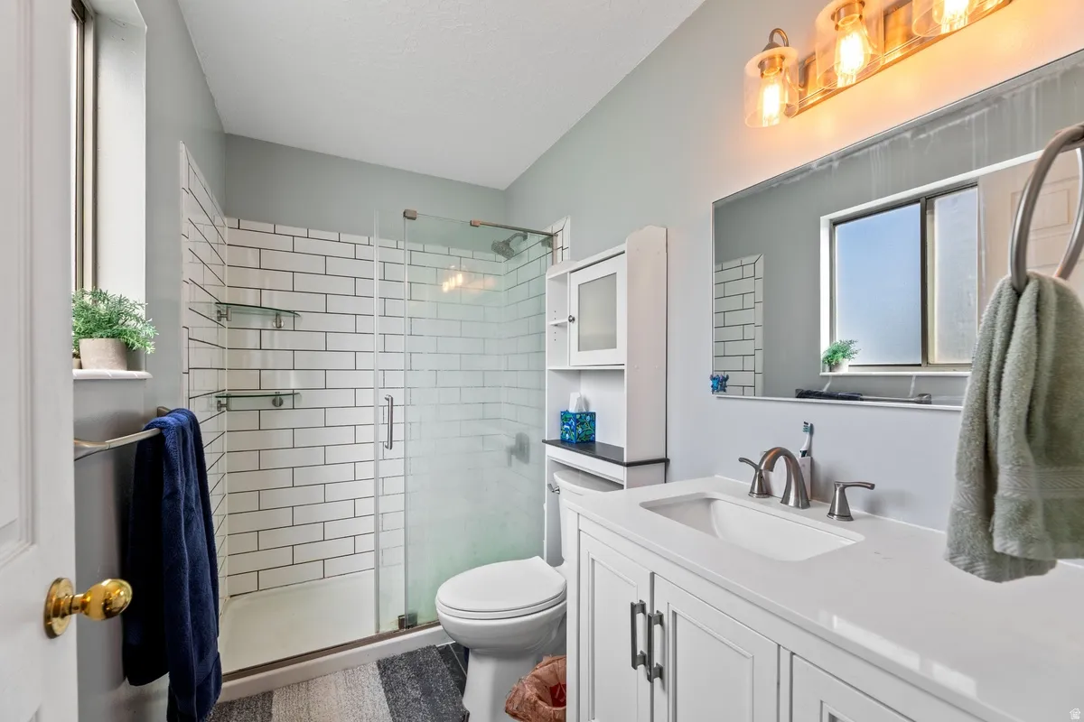 Bathroom featuring vanity and a shower stall