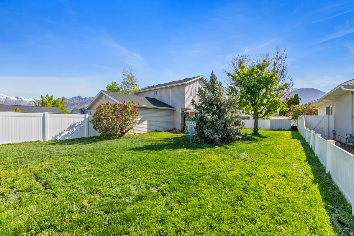 Fenced backyard featuring a mountain view