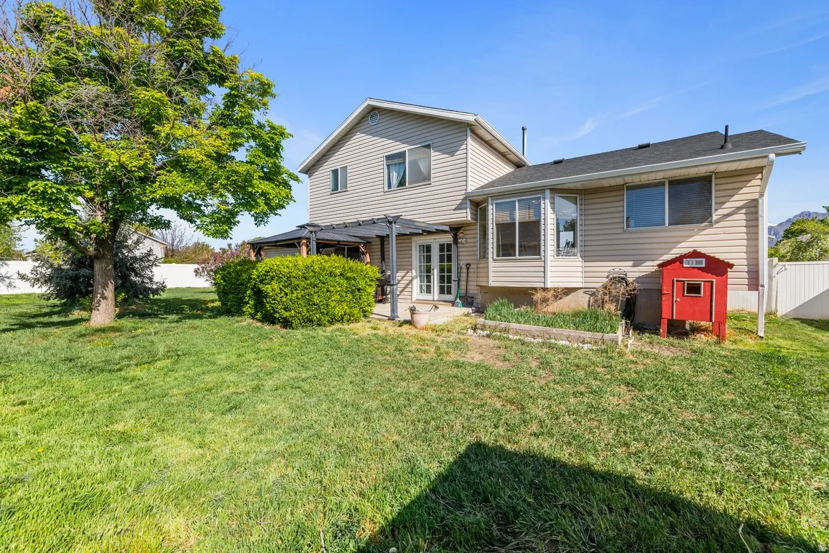 Rear view of house with a fenced backyard