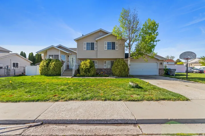 Tri-level home featuring driveway and a garage