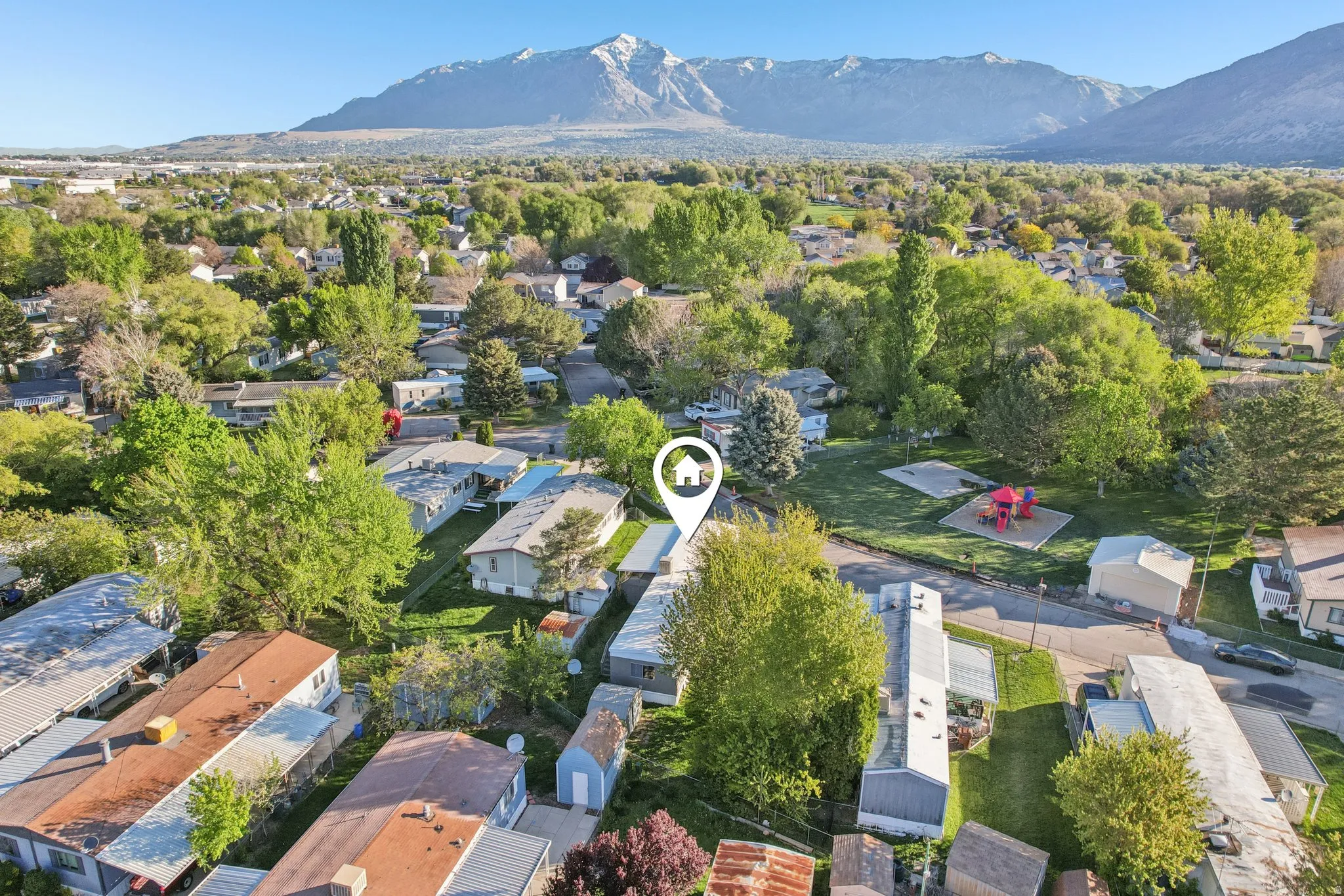Aerial perspective of suburban area with a mountainous background