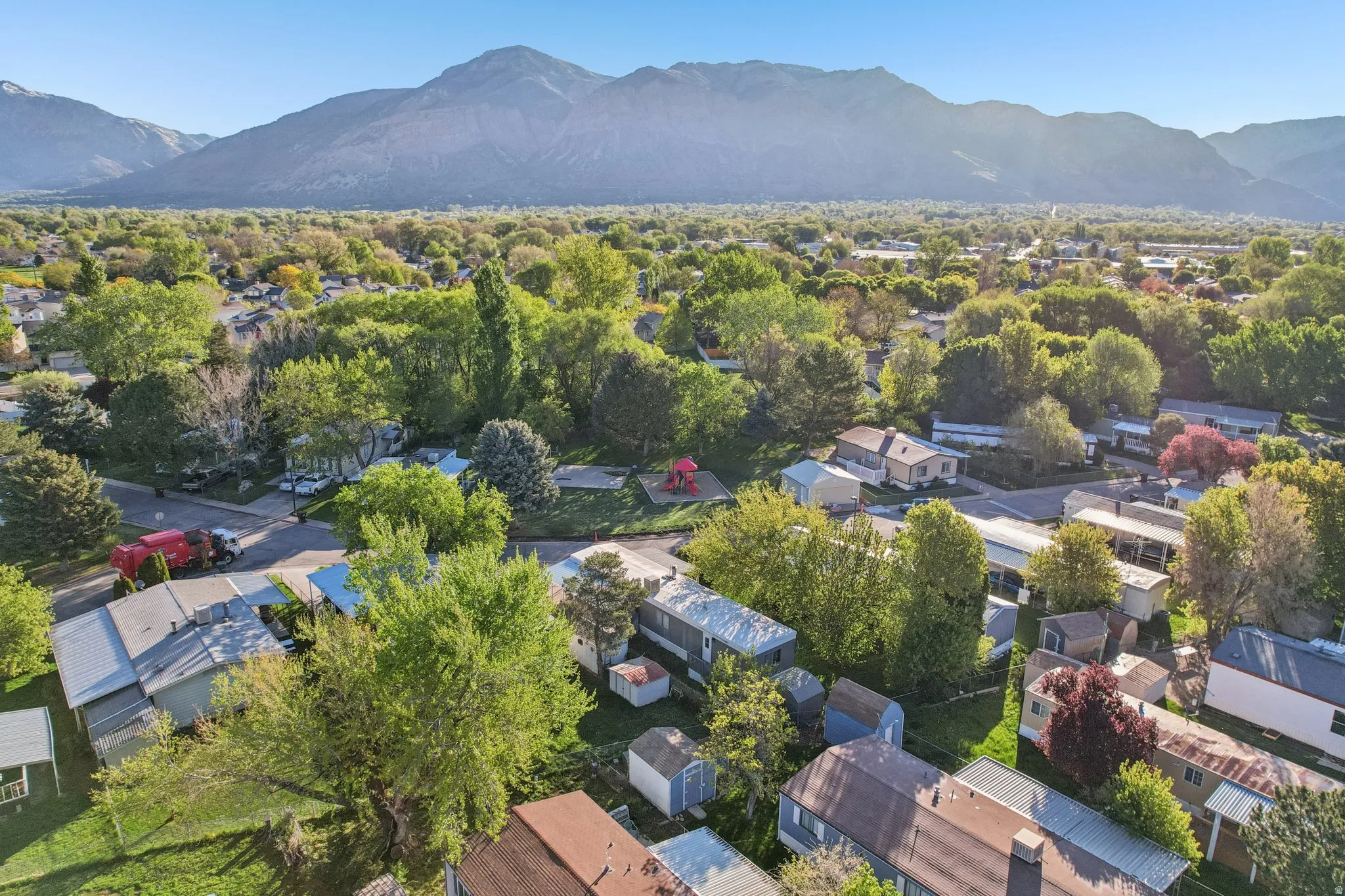 Aerial perspective of suburban area featuring a mountainous background