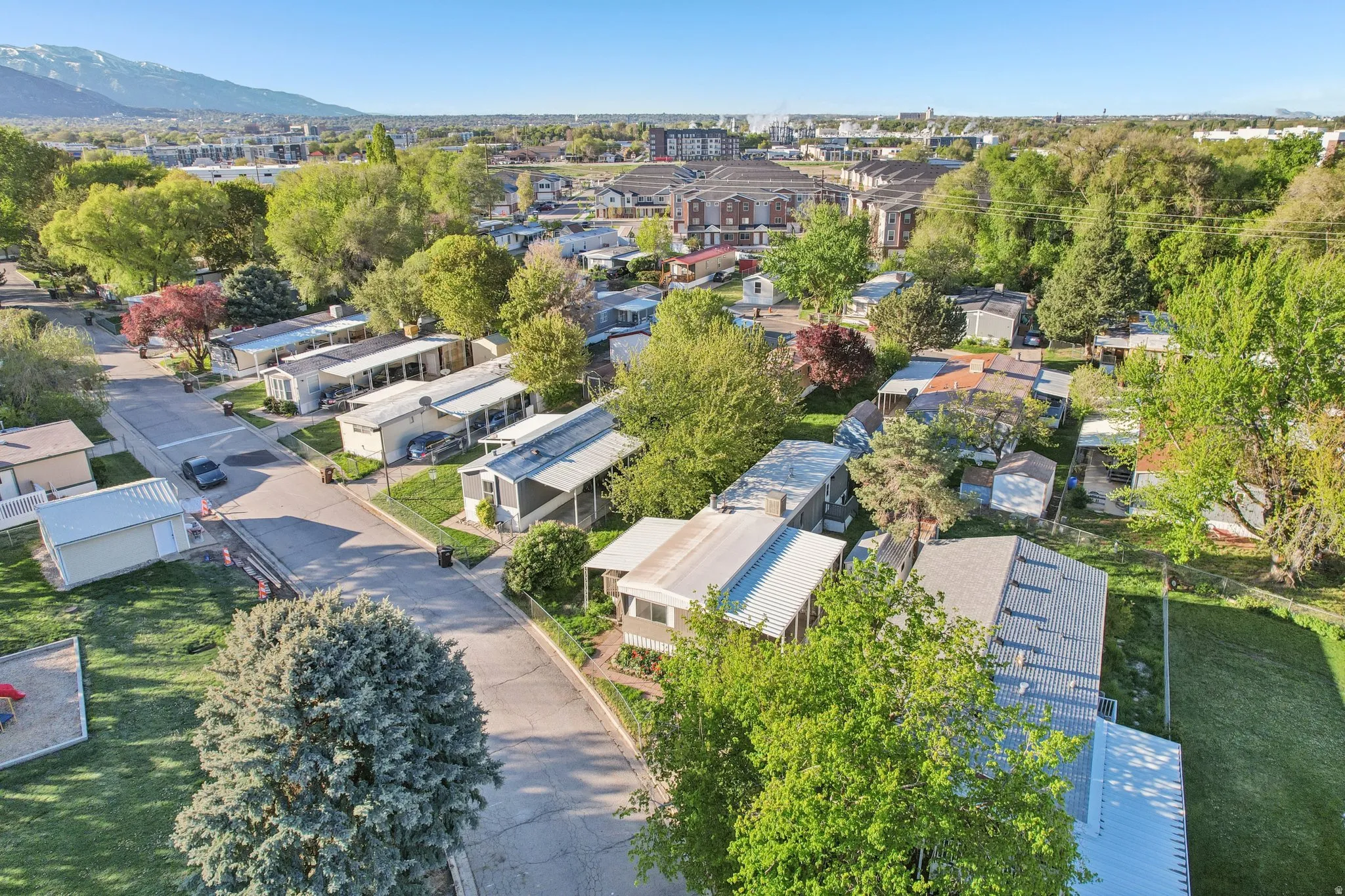 Aerial perspective of suburban area featuring a mountain backdrop