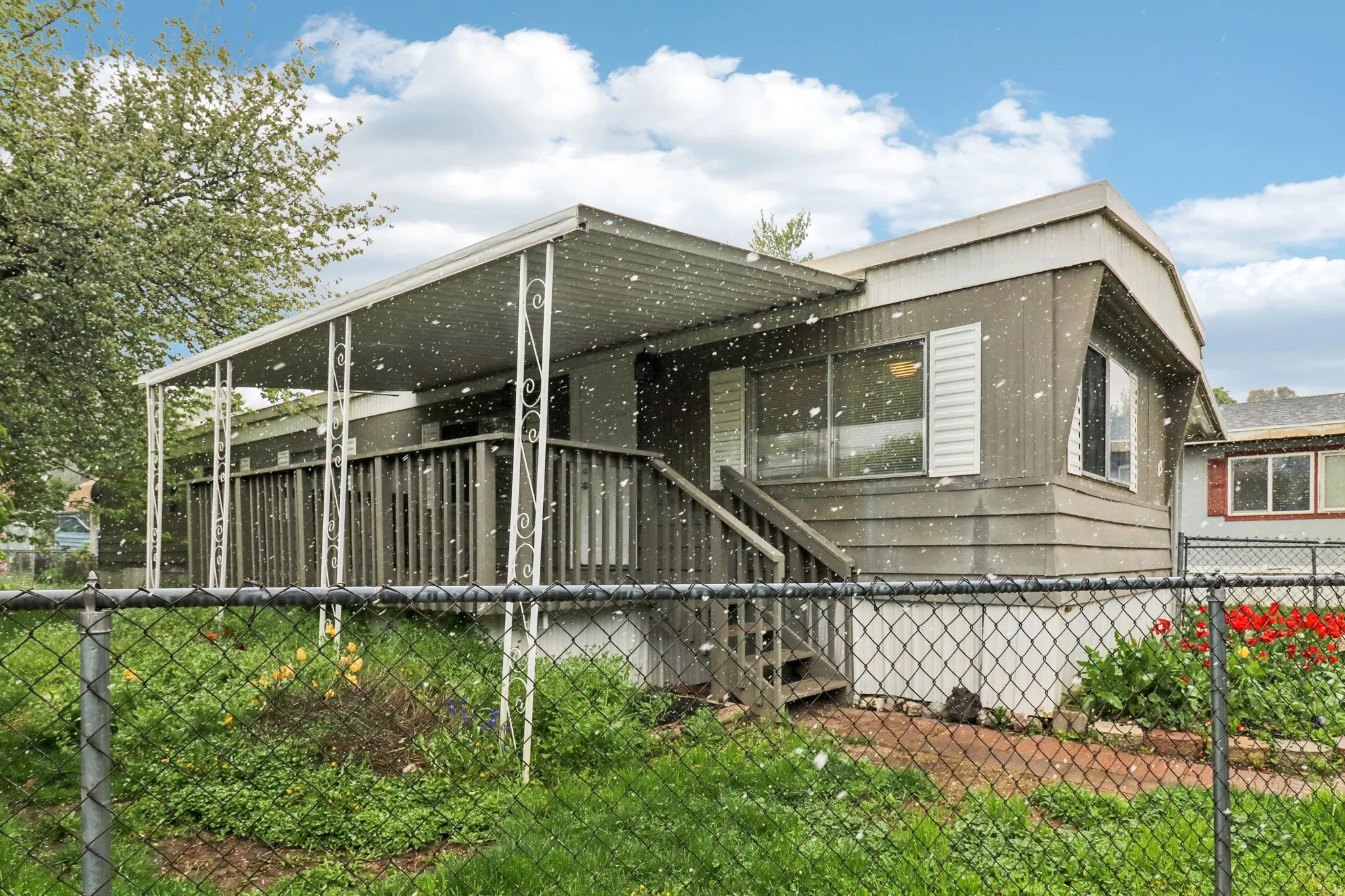 View of side of property with a wooden deck