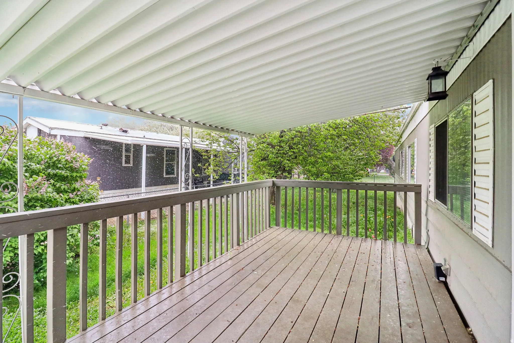 Wooden terrace featuring a lawn
