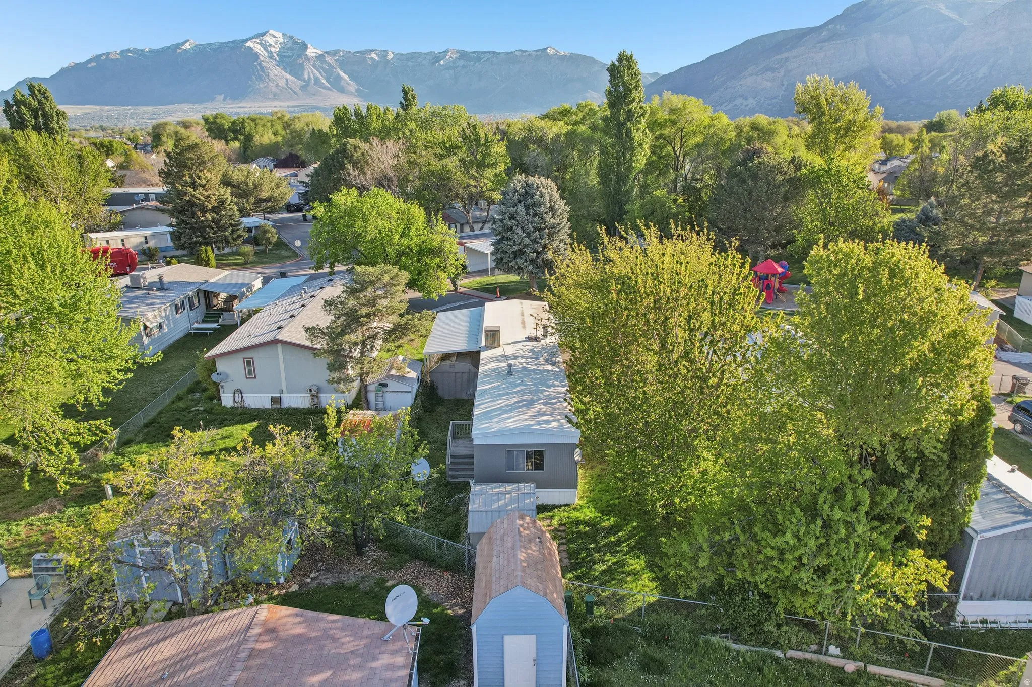 Aerial perspective of suburban area with a mountainous background