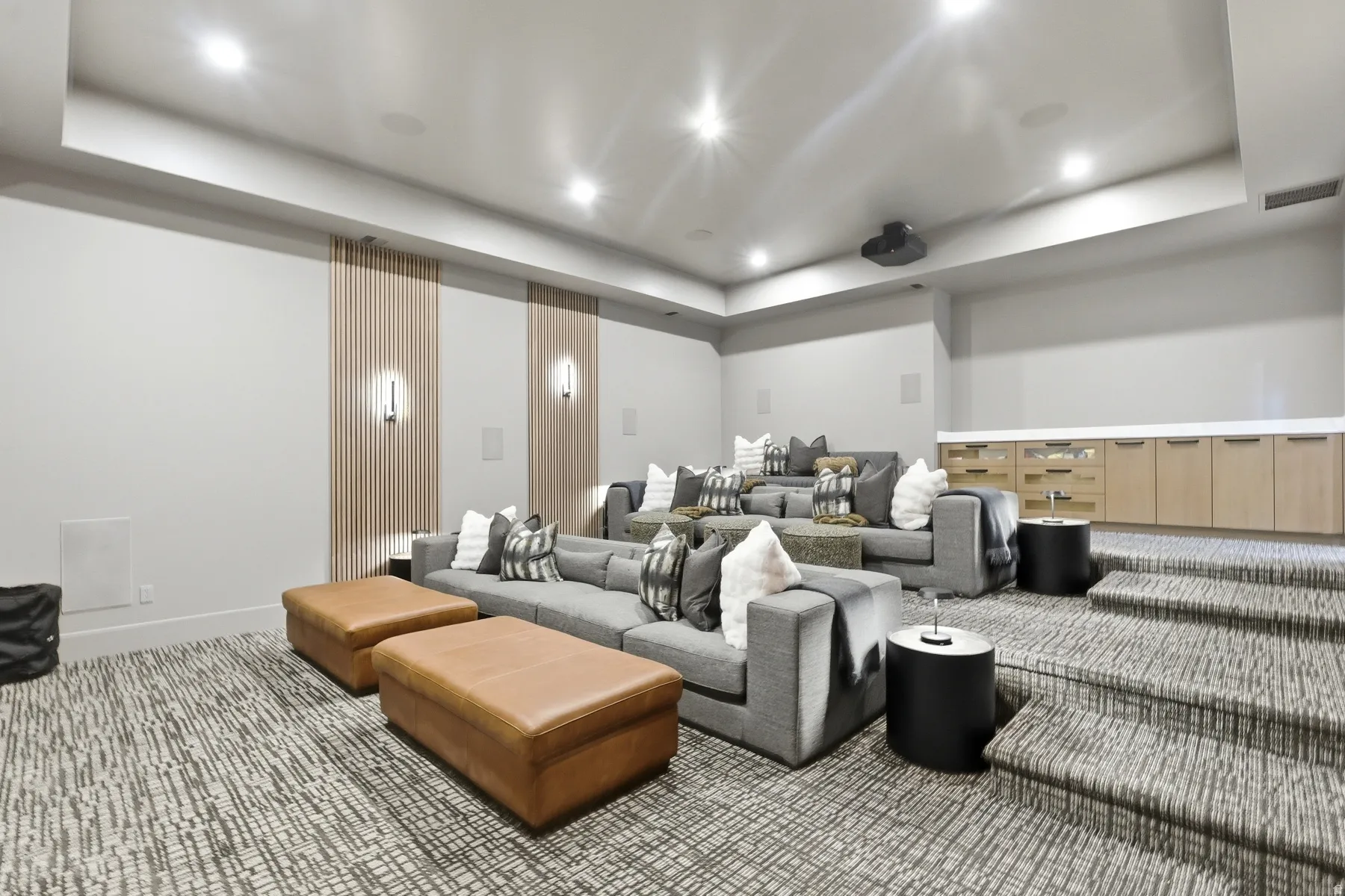 Carpeted home theater room featuring a tray ceiling and recessed lighting