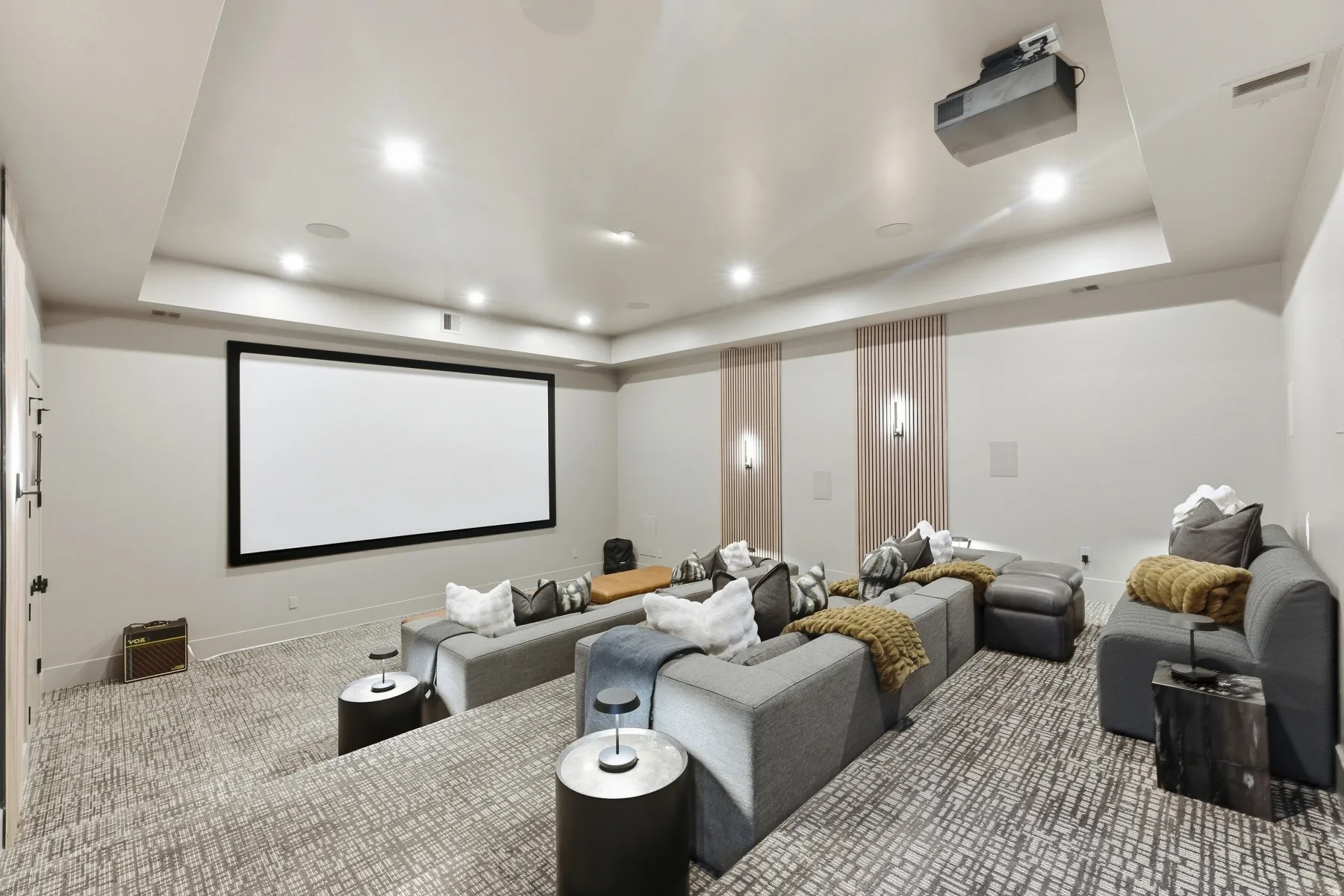 Home theater room featuring a raised ceiling, carpet, and recessed lighting