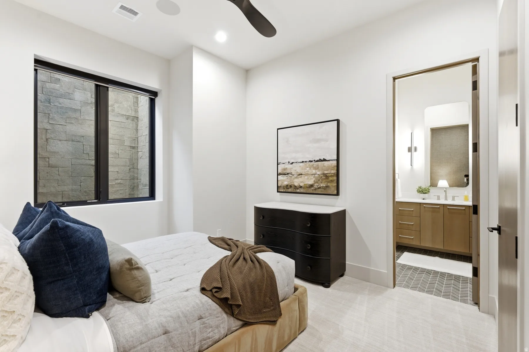 Bedroom featuring light colored carpet, a ceiling fan, recessed lighting, and connected bathroom