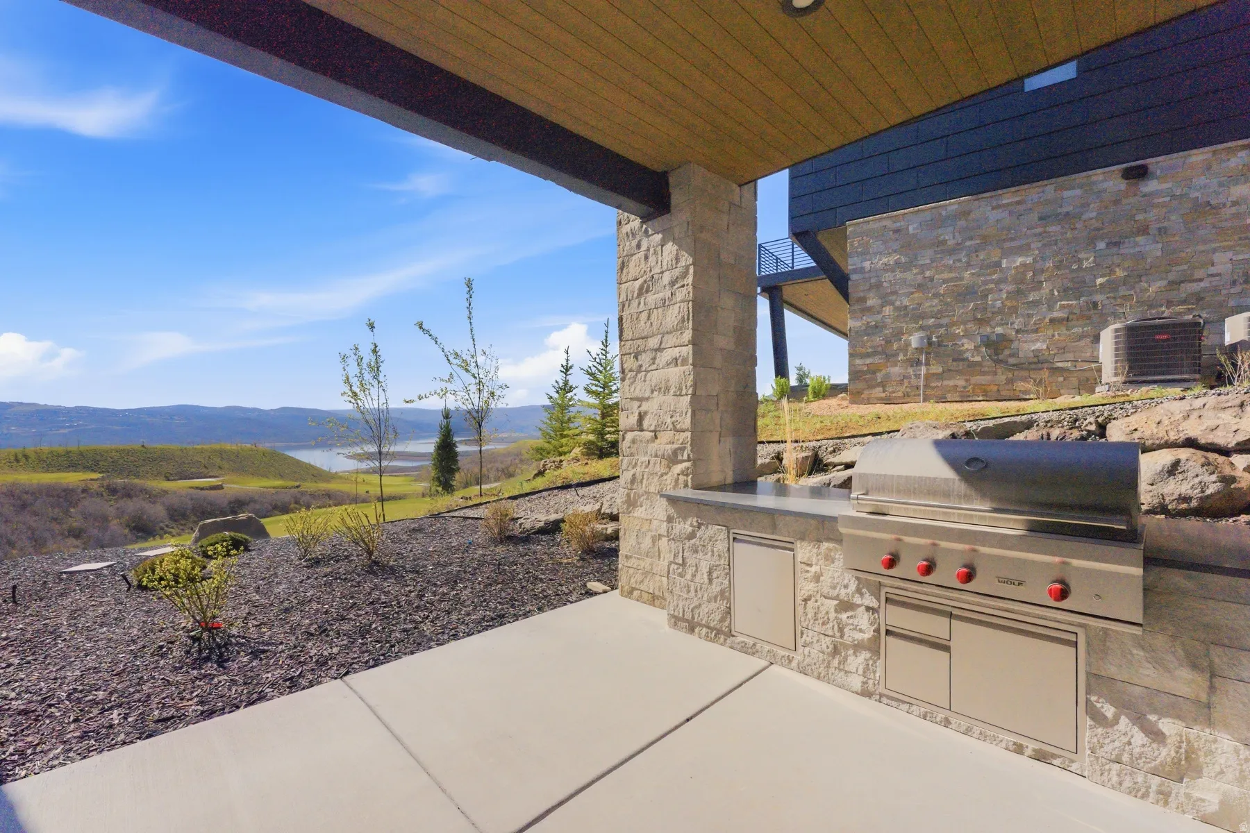 View of patio with a mountain view and exterior kitchen