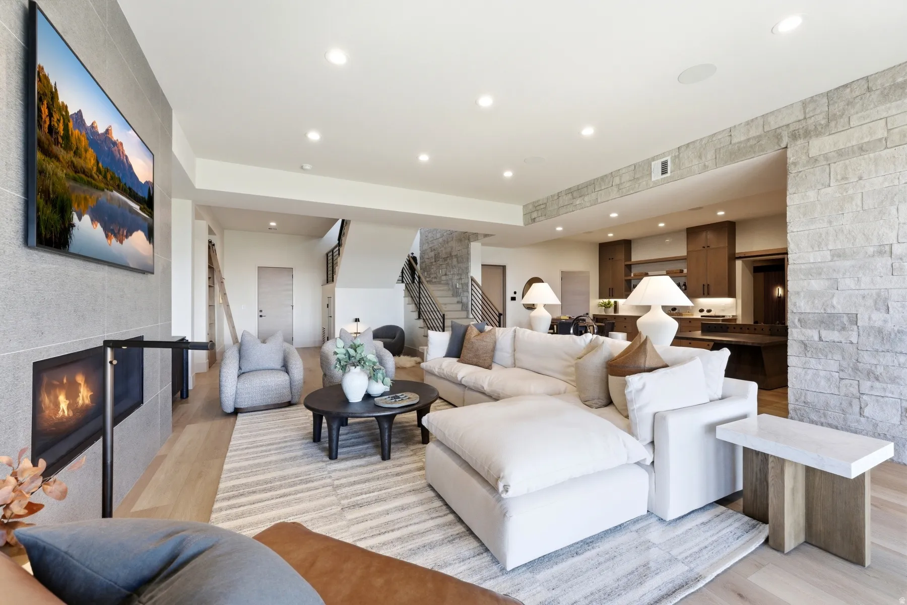 Living area featuring a fireplace, light wood-style floors, and recessed lighting