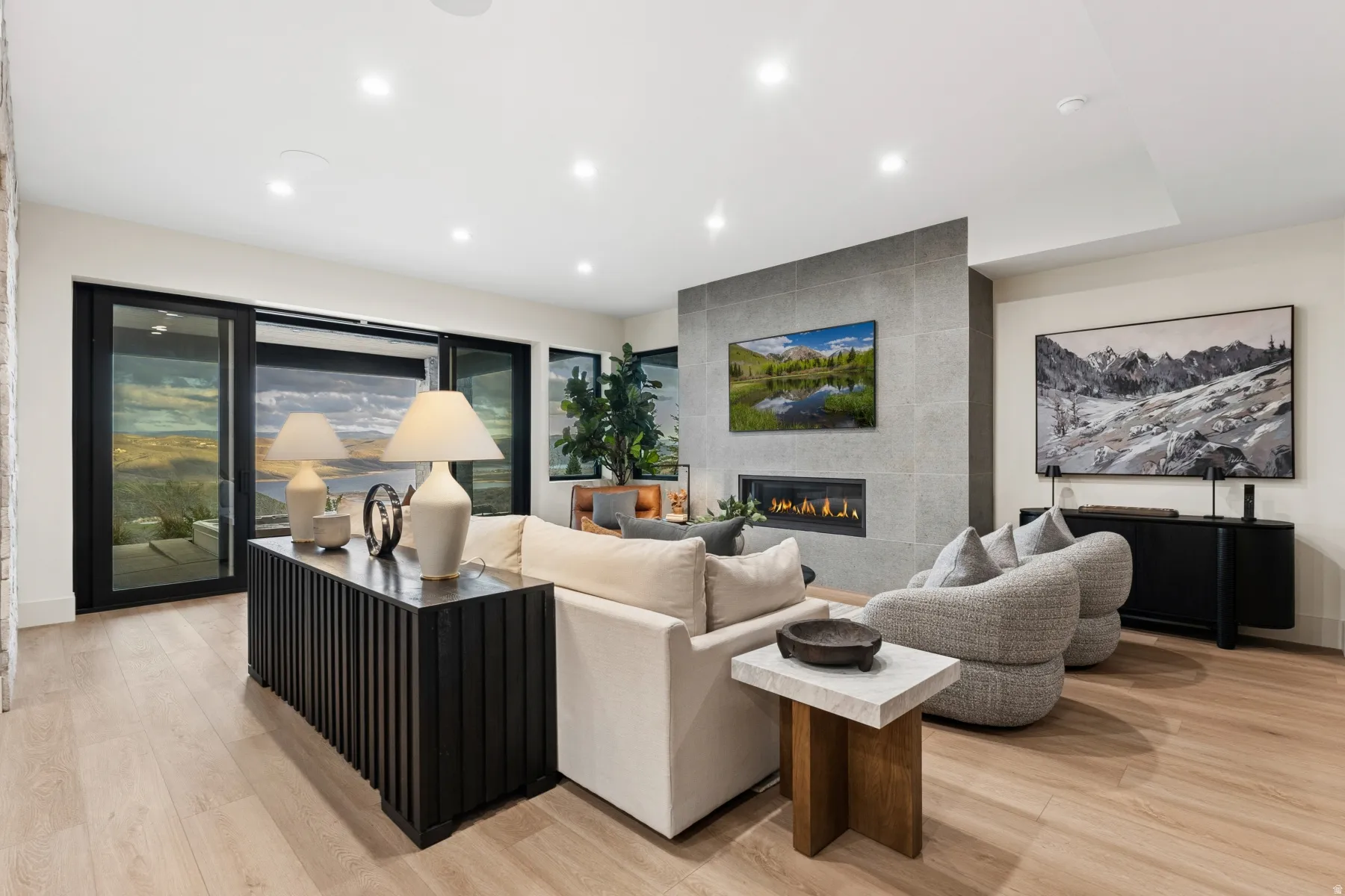 Living room featuring light wood finished floors, recessed lighting, and a tile fireplace