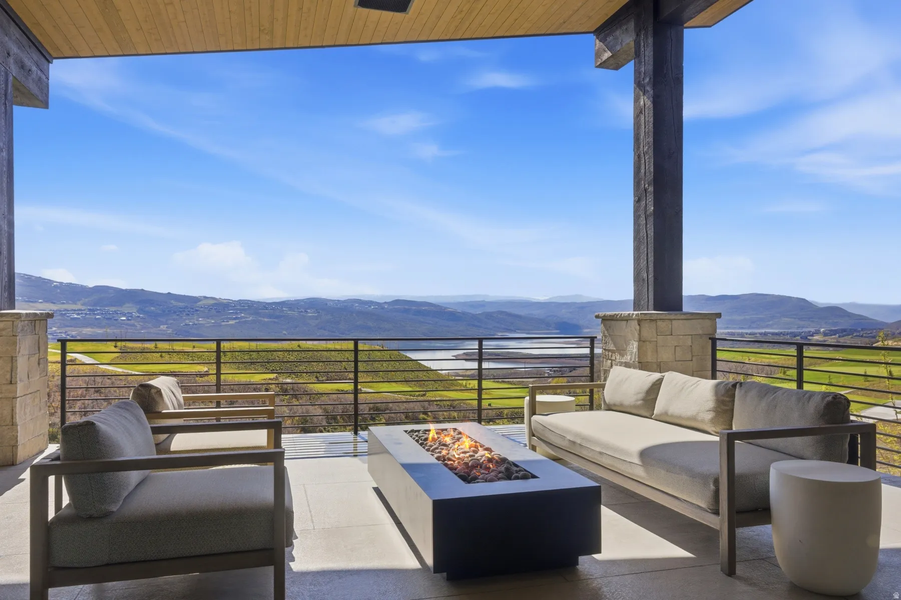 View of patio / terrace with an outdoor living space with a fire pit and a water and mountain view