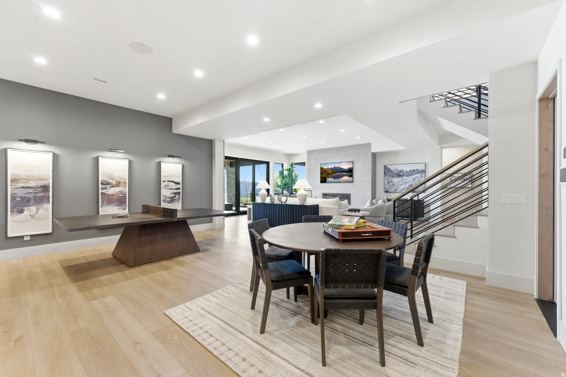Dining room with light wood-style flooring and recessed lighting