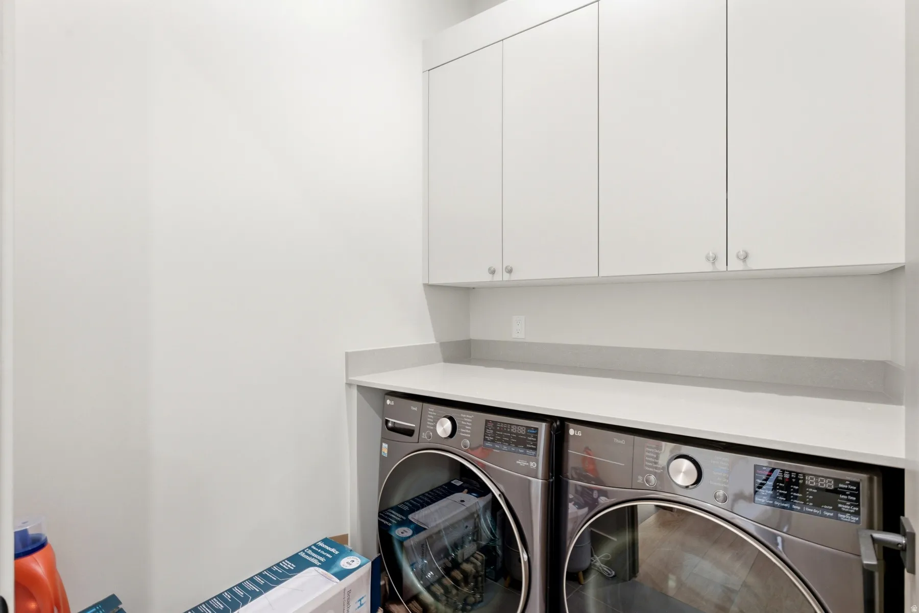 Laundry area with cabinet space and washer and clothes dryer