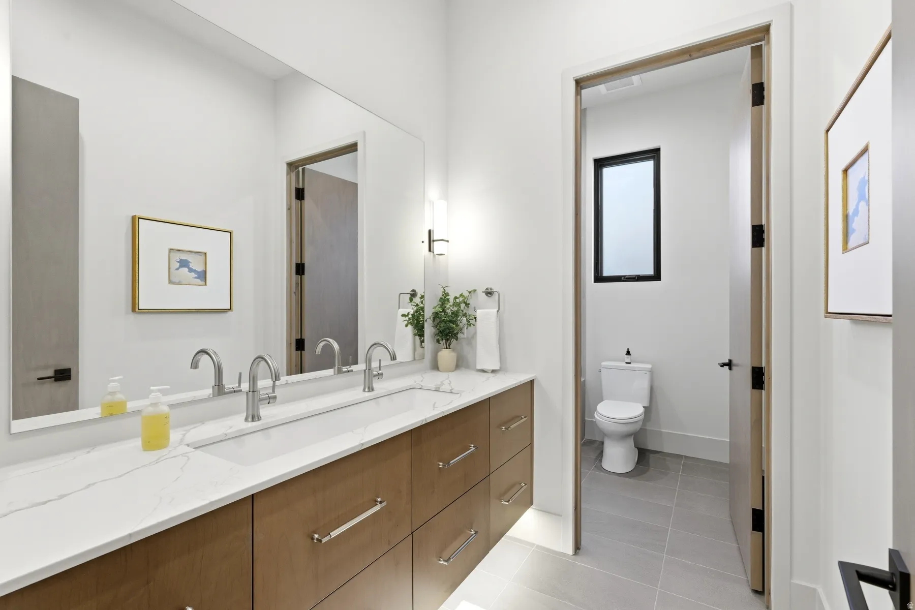 Full bath featuring vanity and light tile patterned flooring