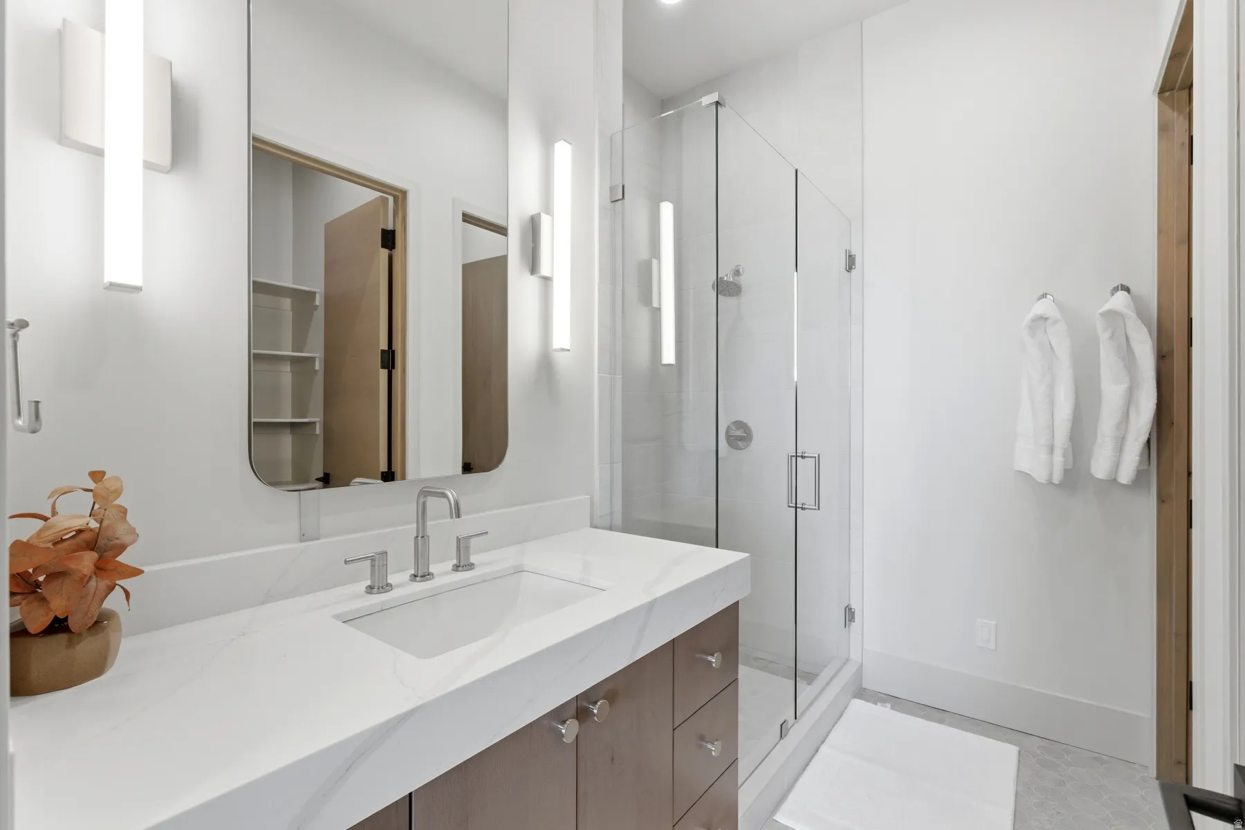 Bathroom featuring vanity and a shower stall