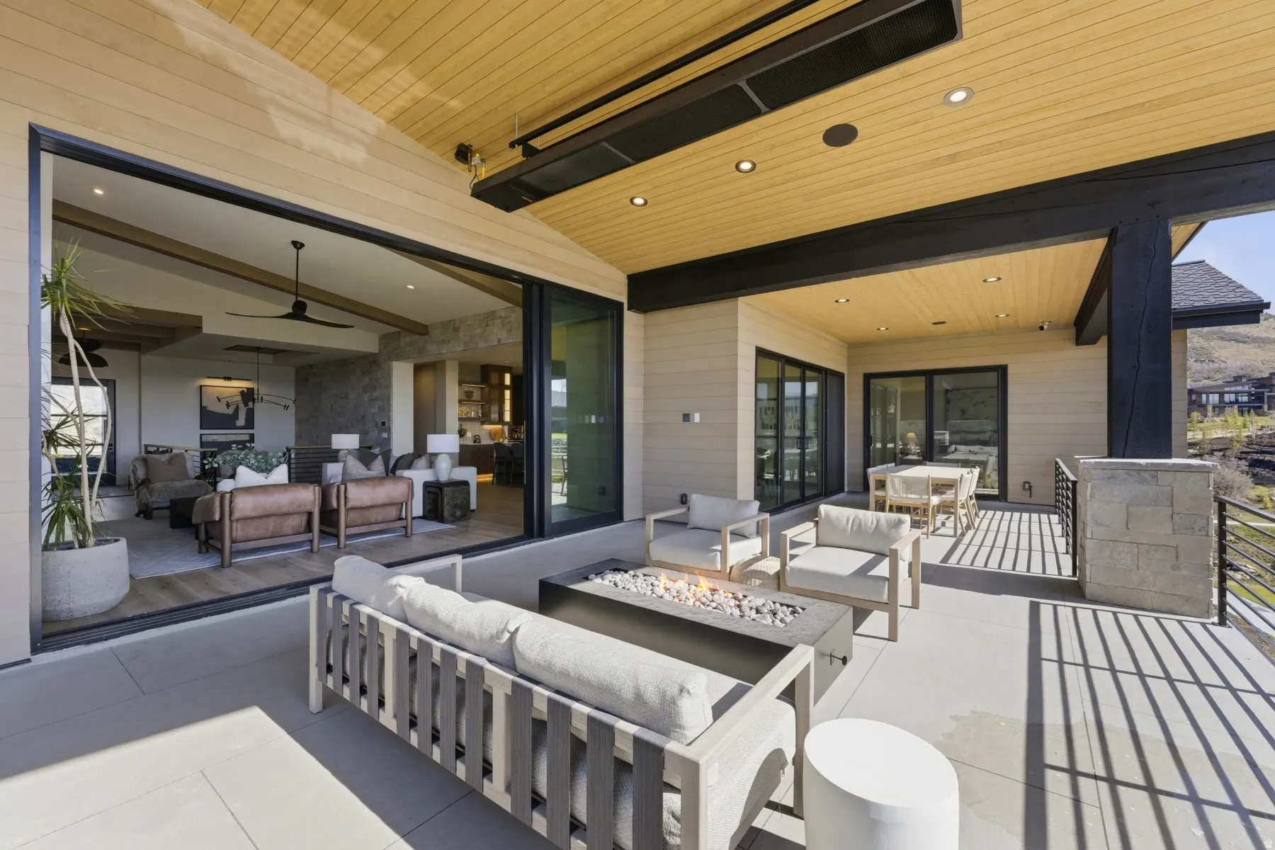 View of patio / terrace with an outdoor living / dining area and a fire pit