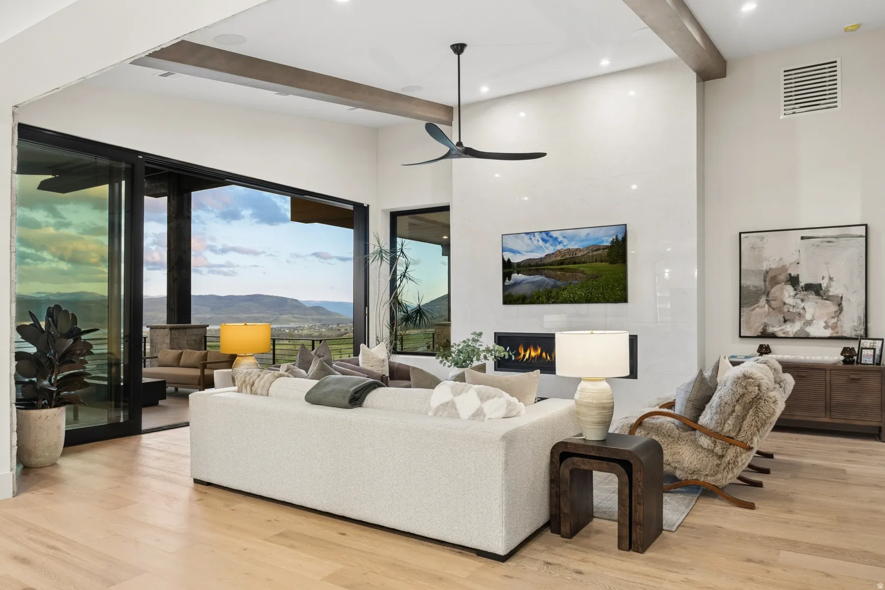 Living area featuring a fireplace, light wood finished floors, a ceiling fan, and recessed lighting